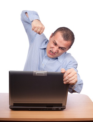 Angry businessman at laptop