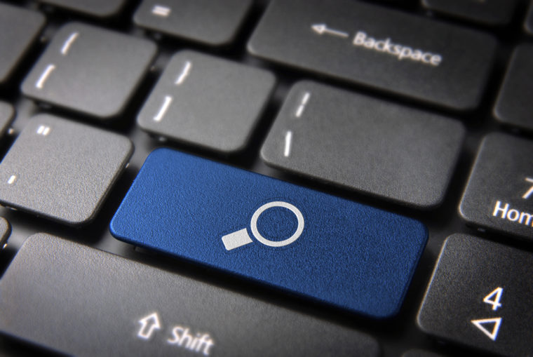 Internet search key with magnifying glass icon on laptop keyboard. Included clipping path, so you can easily edit it.
