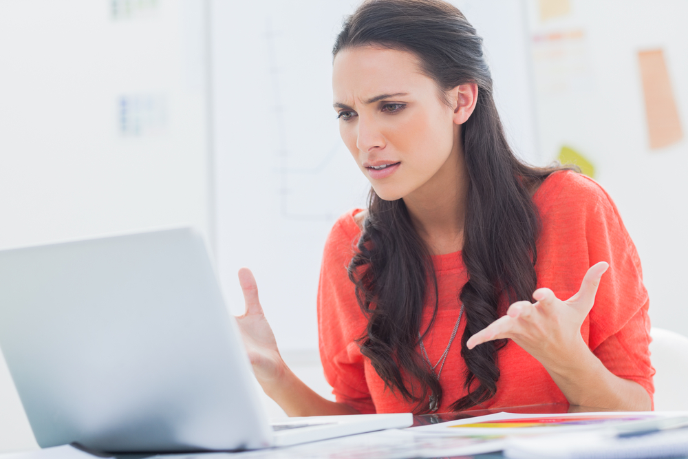 Frustrated woman in front of computer