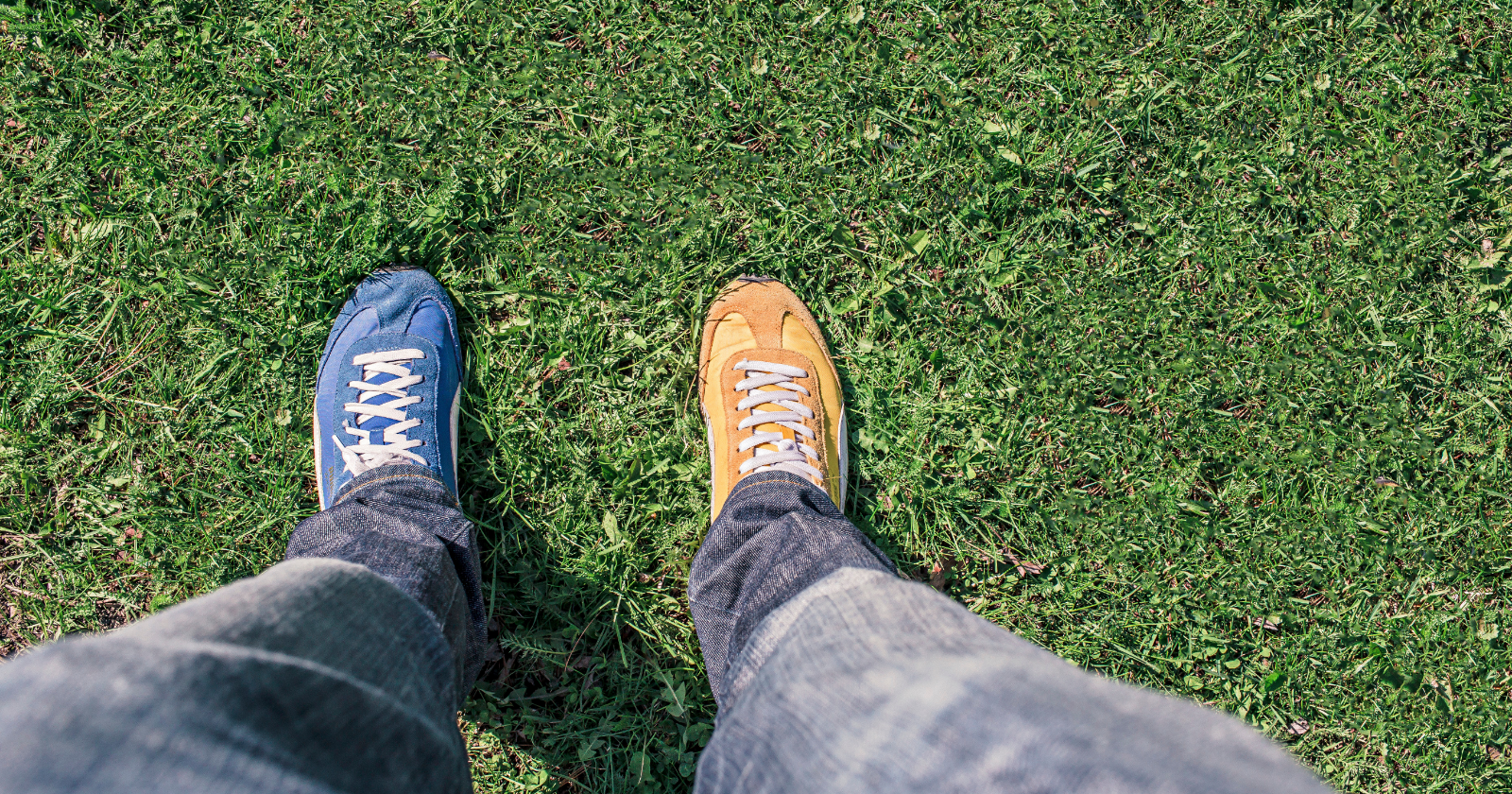 canva-person-wearing-unpaired-running-shoes-standing-on-green-grass