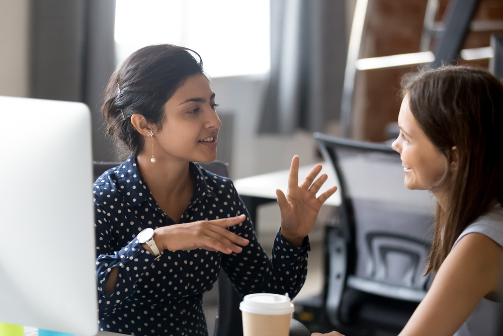 employee discussing with colleague