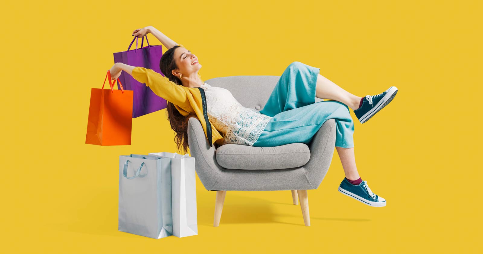 Image of a woman on a couch with shopping bags