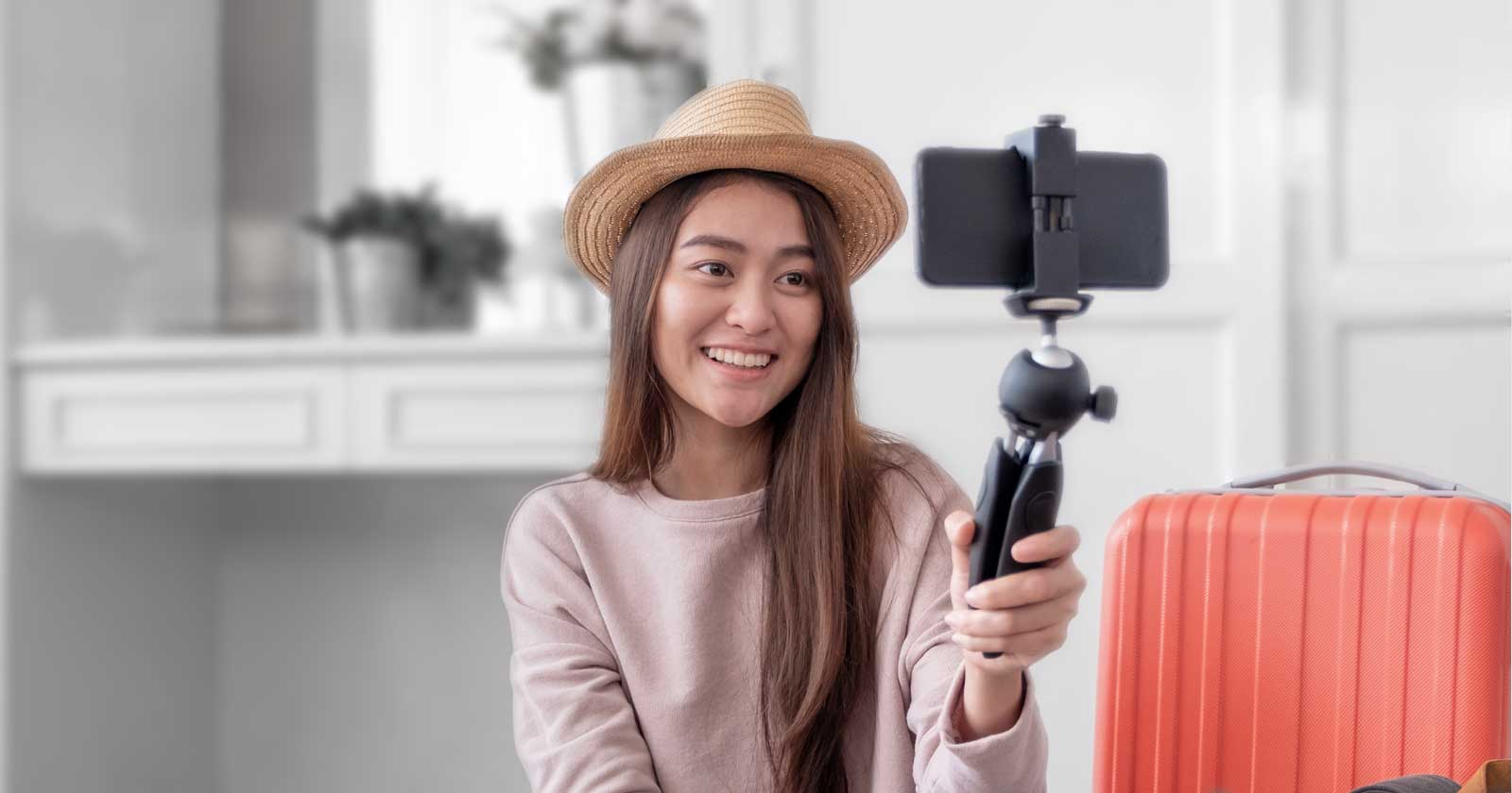 Image of a woman filming herself with a mobile phone