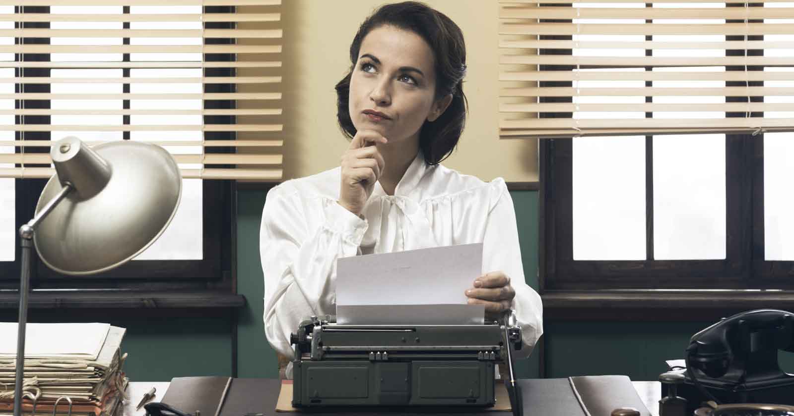 Image of a pensive public relations office woman at a typewriter