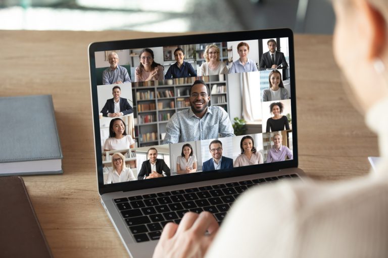 Colleagues gather in a remote video conferencing meeting.