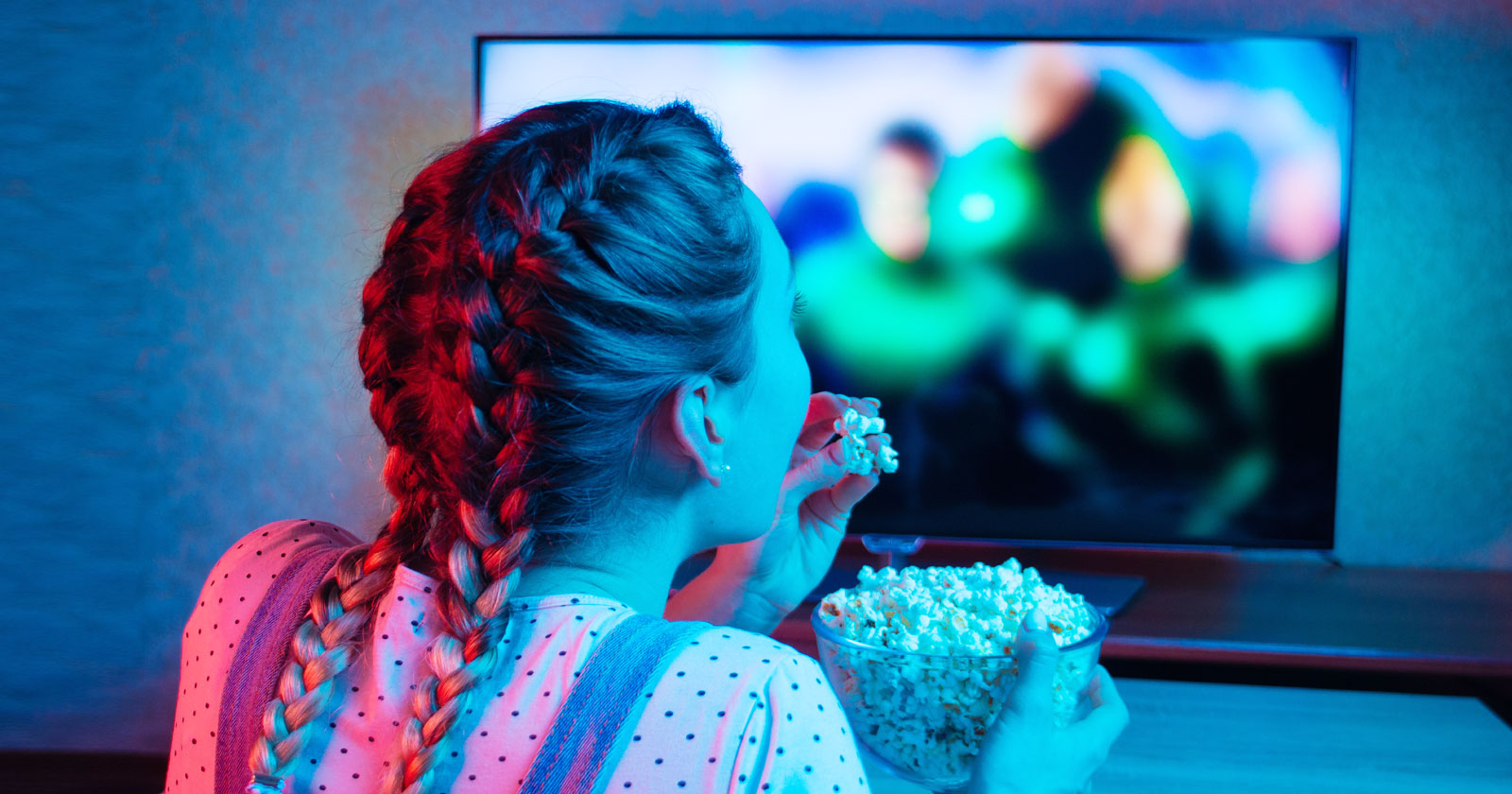 Image of a young woman streaming a movie