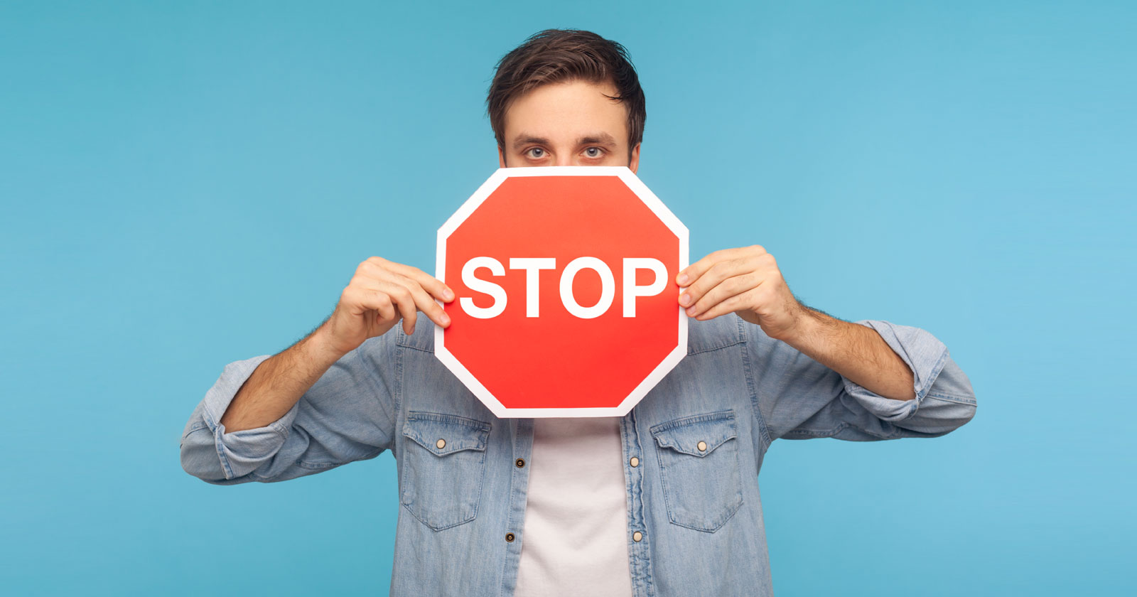 Image of a many holding a stop sign