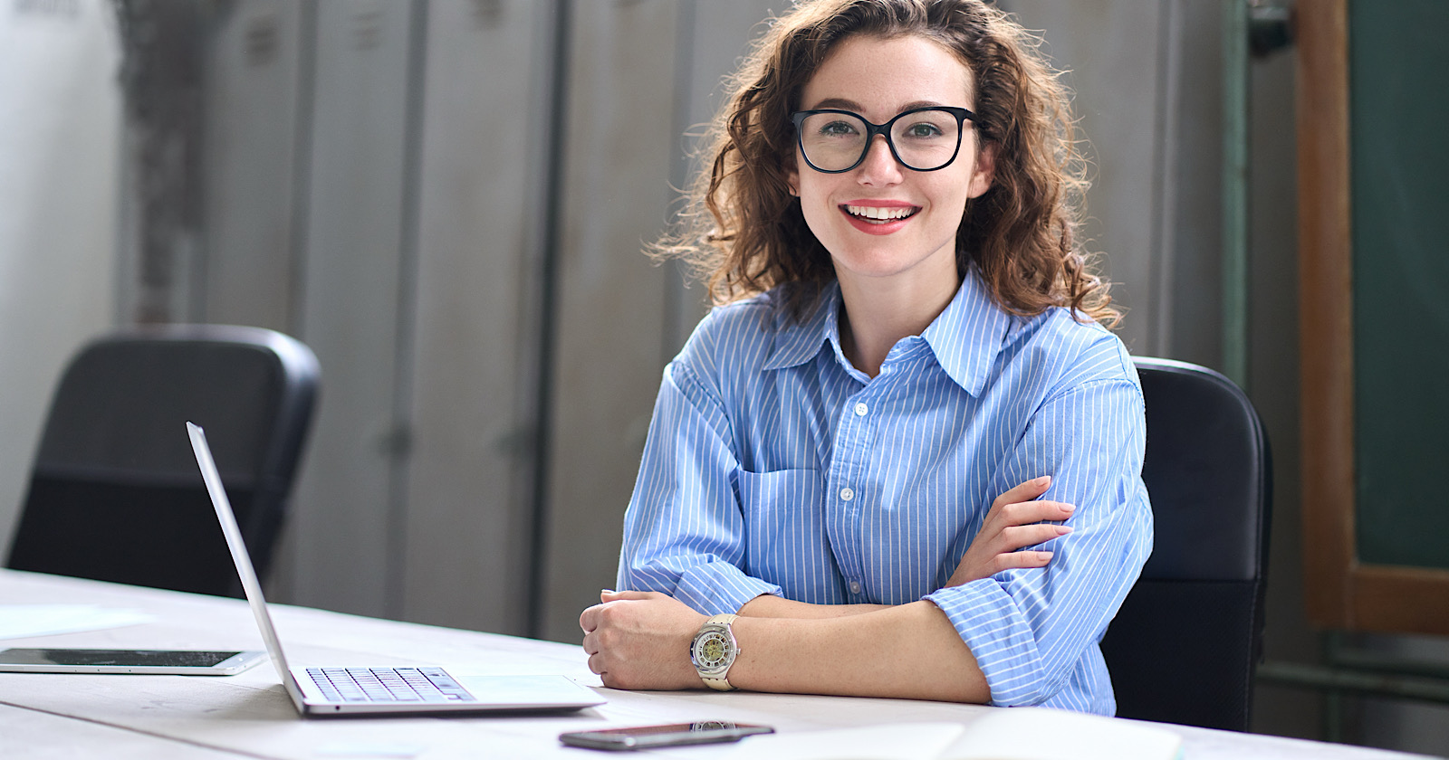 Young happy woman school professional online teacher or tutor sitting at desk with laptop computer, virtual distance classes for students, teaching remote education webinars concept. Portrait