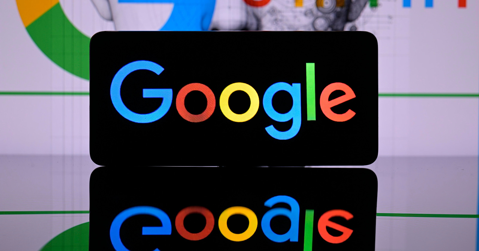 Google is being displayed on a smart phone with Google Gemini seen in the background, seen in this photo illustration.