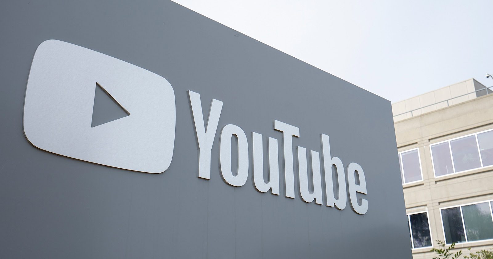 A ample  YouTube Shorts logo connected  the exterior partition  of a building, featuring a bold, achromatic  play   fastener  wrong  a grey  rectangle with the connection     "YouTube" adjacent  to it.