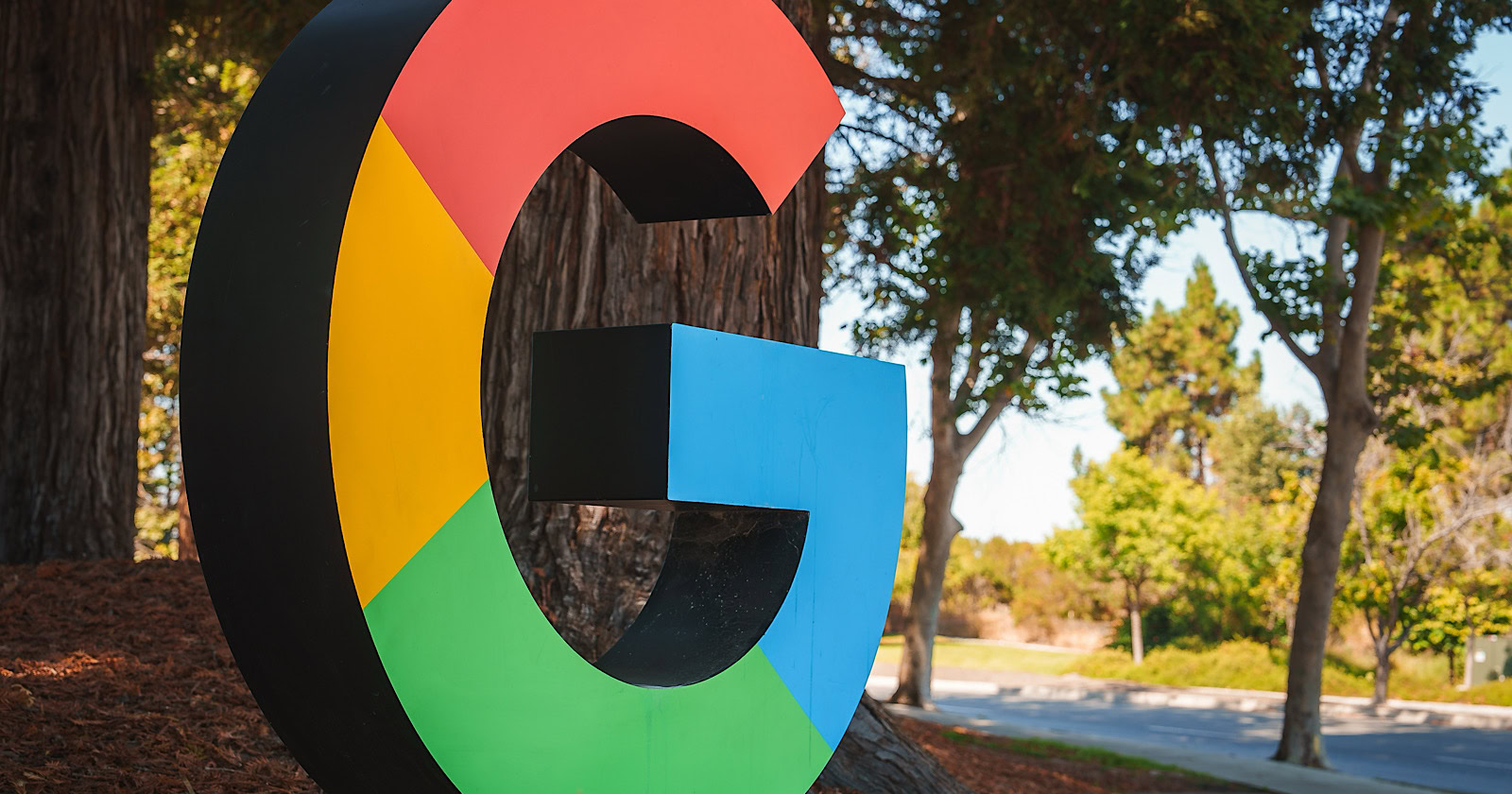 D letter 'G' resembling Google logo colors outdoors in a park like setting. No specific location provided, possibly near Google office or campus.